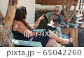 Cheerful old mother and young adult woman talking laughing together 65042260