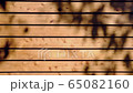 Wooden background and textured with shadow of leaves 65082160