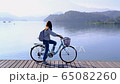 Young woman riding bicycle on Sun Moon lake bike trail, Travel lifestyle concept 65082260