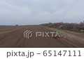 aerial view. tractor and cultivator work in the field 65147111