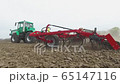 the cultivator plows the ground, the tractor starts work in the field 65147116