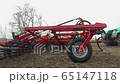 the tractor starts work in the field, the cultivator plows the ground 65147118
