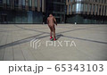 Young man rolls on a skateboard rear view. Longboarding concept on a sunny day. Guy almost fell 65343103