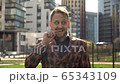 A European man has fun with flower torn from a clearing. The concept of a manager rest at lunchtime 65343109