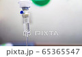 Cinemagraph of a fluid intravenous saline drip in a hospital room 65365547