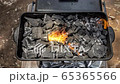 Cinemagraph of a burning fire on burnt coal in a BBQ grill 65365566