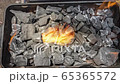 Cinemagraph of a burning fire on burnt coal in a BBQ grill 65365572