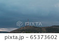 Communication antenna on top of a mountain, a stormy evening 65373602