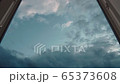 Beautiful clouds fly outside the window 65373608