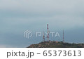 Mountain with a television antenna on a background of a stormy sky 65373613