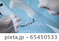 Close up of cleaning of a coronavirus face shield. 65450533