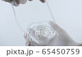 Putting on oxygen mask. White surgical gloves in sterile environment 65450759