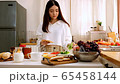 Cute happy asian woman made sandwich in the morning kitchen. 65458144