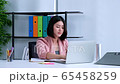 Portrait of serious young asian woman using laptop in office. 65458259