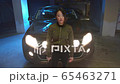 Asian woman with a gun crosses her arms. Slowmotion 65463271