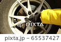 Woman shows by finger an order of screwing and unsckrewing wheel screws 65537427