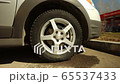 Side view of car wheel before replacement 65537433