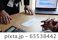 Angry employee walked into the manager room and threw an envelope wanting to leave the company to the desk while the employer was sitting working in his room. 65538442