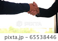 Two businessmen entrepreneurs or job interviews go well and shaking hands with confidence slow motion. 65538446
