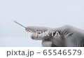 Holding swab for coronavirus testing. Nurse with white medical gloves. 65546579