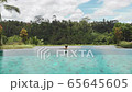 Woman relaxing in infinity swimming pool 65645605
