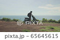 Traveller man on scooter 65645615