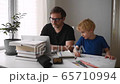 Man working from home with laptop during quarantine. Home office and parenthood at same time 65710994