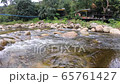 calm mountain water stream flowing with house waterside 65761427
