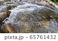 Calm mountain water stream flowing, The movement of a mountain river. 65761432