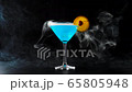 Blue cocktail. White smoke or floating fog cloud in slow motion spreading down from a glass with a blue summer cocktail on a black table against black background. Concept of alcohol cocktail party. 4K 65805948