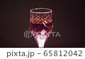 Glass of red wine on a black background 65812042