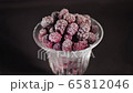 Raspberry berries in a glass on a black background 65812046