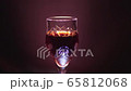 Glass of red wine on a black background 65812068