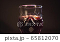 Glass of red wine on a black background 65812070