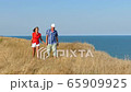 4K. Adult attractive couple walk against  sea in summer day     65909925