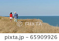 4K. Adult attractive couple walk against  sea in summer day     65909926