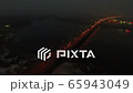 4K Aerial. Night City highway with car traffic and  bridge over river, Camera inclination 65943049