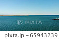 Small red lighthouse and embankment 65943239