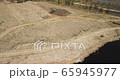 Aerial view of waste disposal open dump. Machine working in landfill. 65945977