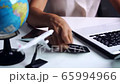 Young woman holding credit card and planning vacation trip with laptop, Travel planning concept 65994966