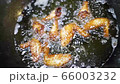 Chicken deep fry in hot oil close up in a Chinese restaurant. Progress of making Vietnamese asian 66003232