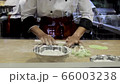 An asian chef making bread by forming power on the table. Close up to the hand working in restaurant 66003238