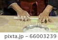 An asian chef making bread by forming power on the table. Close up to the hand working in restaurant 66003239