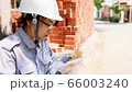Blue collar worker taking a break at noon. Close up of women eating bread and reading a letter on 66003240
