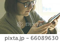 Caucasian woman with glasses using tablet 66089630
