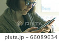 Caucasian woman with glasses using tablet 66089634