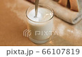 Stir the milk in a close-up glass. The concept of making a milkshake 66107819