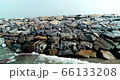 Waves splashing sea defence rocks 4K 66133208