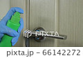Human hand in latex glove applies disinfectant antiviral spray on handle door office or home. Cleaning Company sanitizing, protecting infection, virus, covid 19, coronavirus, bacteria disinfection 66142272