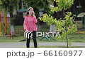 Young beautiful girl in park calling with mobile phone. 66160977